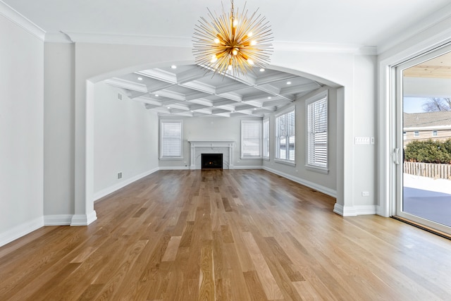 unfurnished living room with beam ceiling, coffered ceiling, crown molding, hardwood / wood-style flooring, and a chandelier