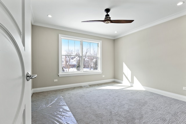 carpeted empty room featuring ceiling fan and ornamental molding