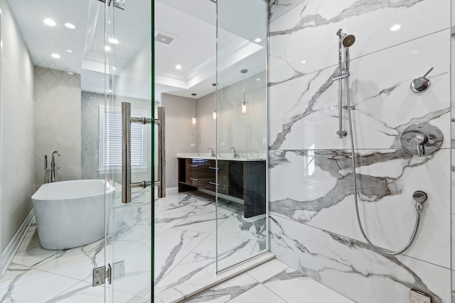 bathroom with vanity, shower with separate bathtub, and a tray ceiling