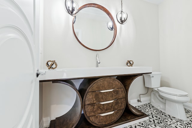 bathroom featuring toilet and tile patterned flooring