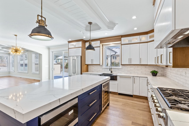 kitchen featuring white cabinetry, a center island, stainless steel appliances, and pendant lighting