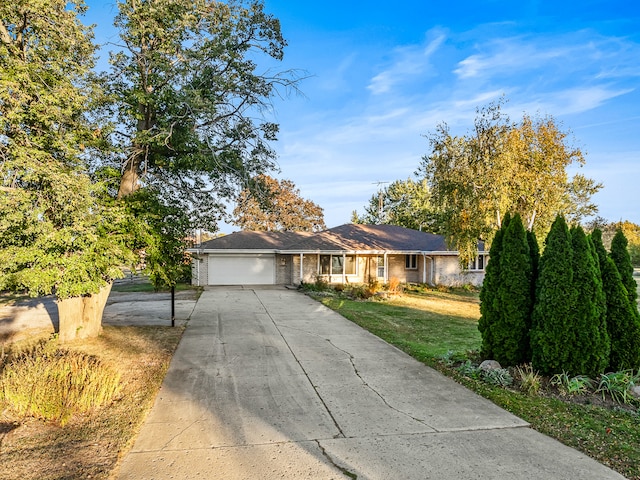 single story home with a garage and a front lawn