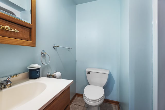 bathroom with vanity, toilet, and tile patterned floors