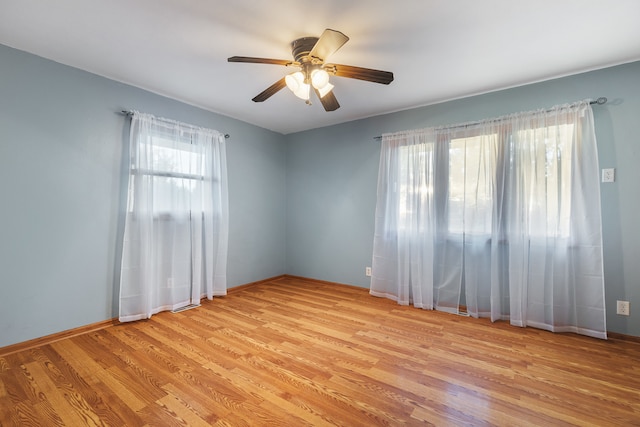 unfurnished room with light hardwood / wood-style flooring and ceiling fan