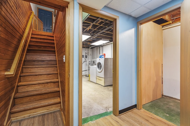 staircase featuring independent washer and dryer and hardwood / wood-style flooring