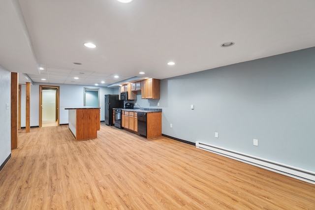 kitchen with a baseboard heating unit, light wood-type flooring, black appliances, sink, and a center island