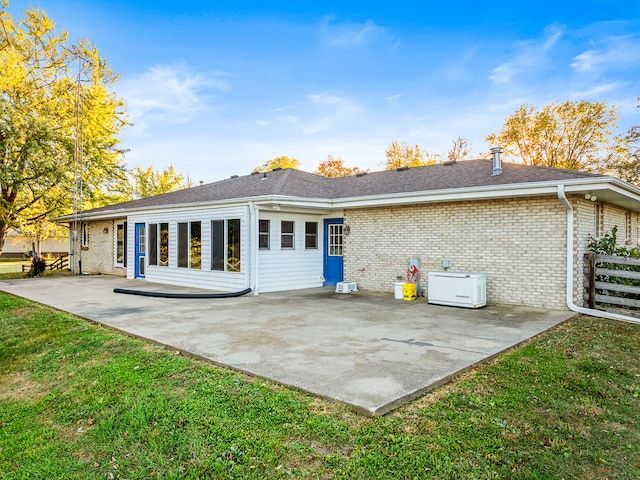 rear view of property featuring a patio and a yard