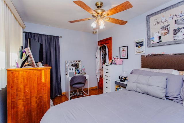 bedroom with a closet, hardwood / wood-style floors, and ceiling fan