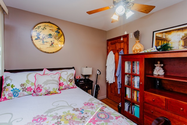 bedroom featuring wood-type flooring and ceiling fan