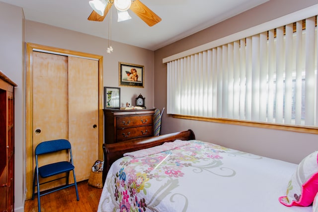 bedroom with hardwood / wood-style flooring, a closet, and ceiling fan