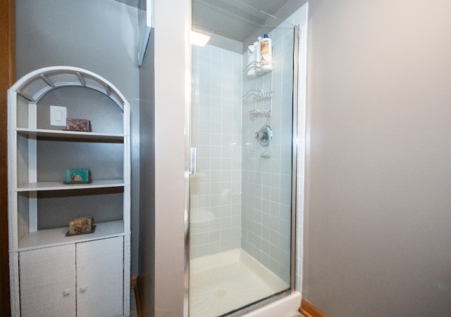 bathroom with a shower with shower door