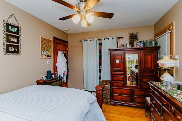 bedroom with light hardwood / wood-style flooring and ceiling fan