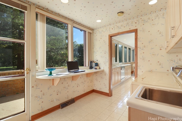 interior space with sink, light tile patterned floors, and dishwasher