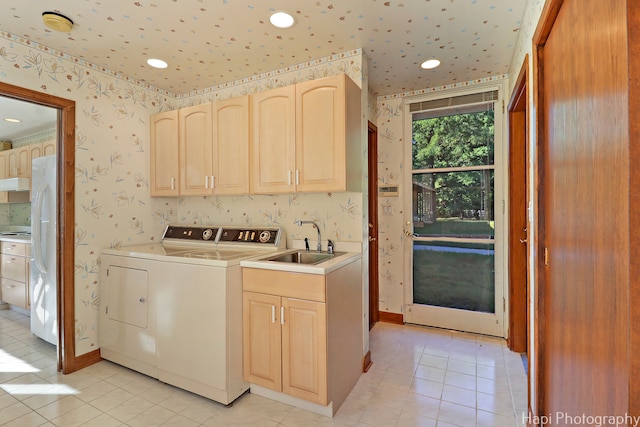 washroom with washer and dryer, cabinets, sink, and light tile patterned floors