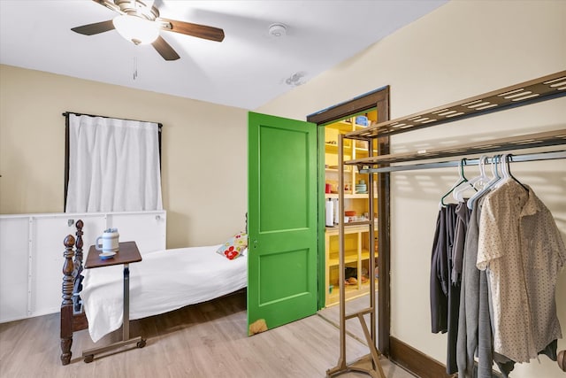 bedroom with hardwood / wood-style floors and ceiling fan