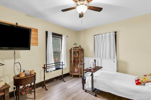 bedroom with light hardwood / wood-style flooring and ceiling fan