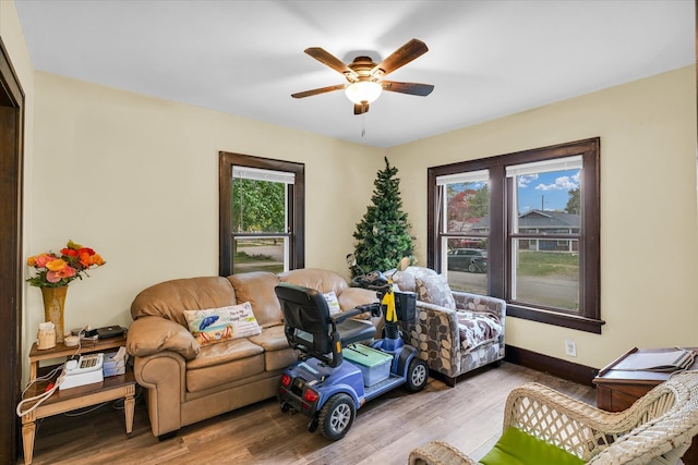 living room featuring light hardwood / wood-style floors and ceiling fan