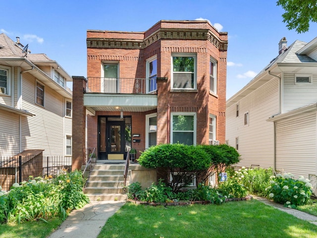 view of front of house with a front lawn and a balcony