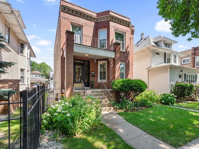 view of property featuring a front lawn and a balcony