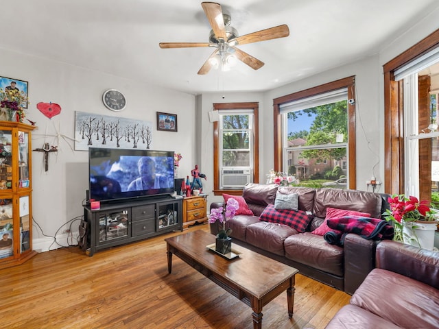 living room with light hardwood / wood-style flooring, cooling unit, and ceiling fan