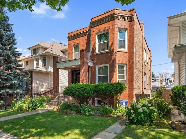 view of front of house with a front yard and a balcony