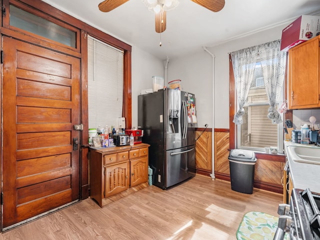 kitchen featuring stainless steel fridge, light hardwood / wood-style flooring, and ceiling fan