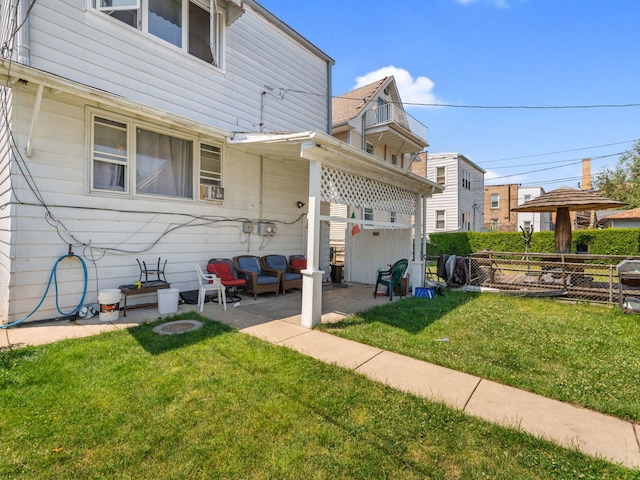 back of property featuring a yard and a patio area