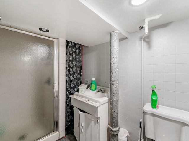 bathroom with vanity, toilet, and a shower with shower door