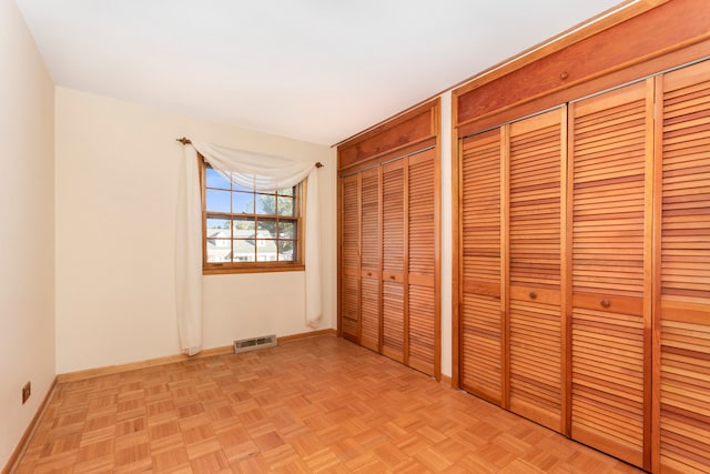 unfurnished bedroom with light parquet flooring