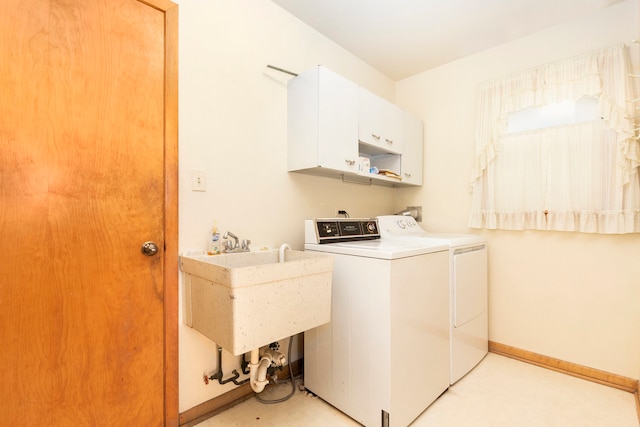 washroom featuring cabinets, washer and dryer, and sink