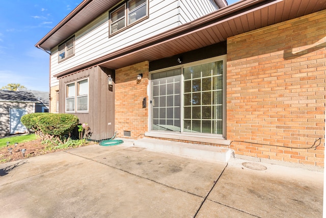 entrance to property with a patio area