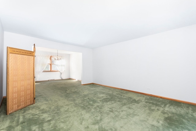 unfurnished room featuring an inviting chandelier and dark carpet