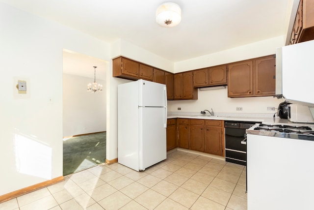 kitchen featuring black dishwasher, an inviting chandelier, pendant lighting, white fridge, and sink