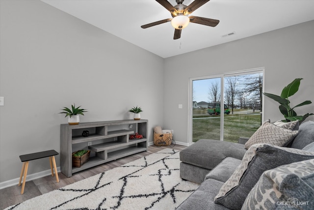 living room with hardwood / wood-style floors and ceiling fan