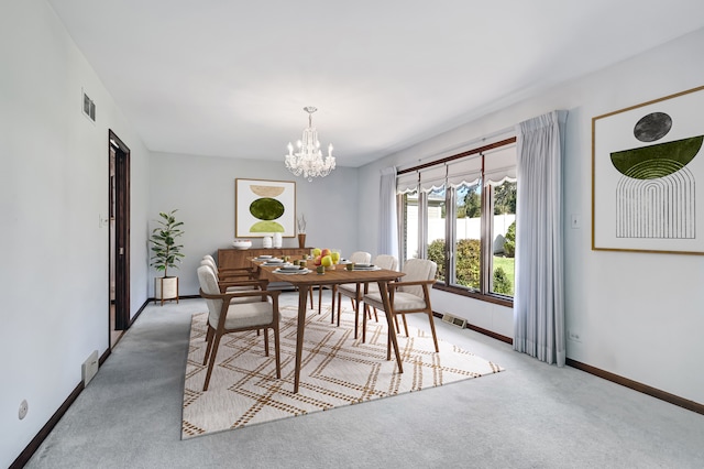 dining area featuring carpet and a chandelier