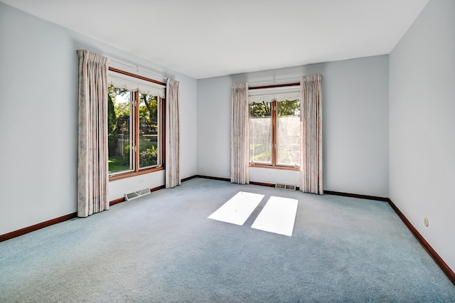 spare room with light colored carpet