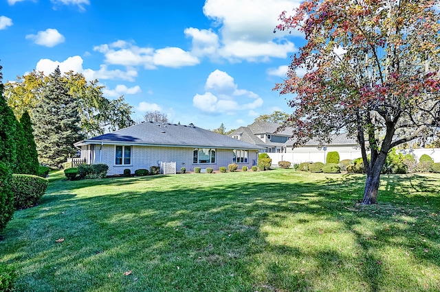 back of property with a lawn