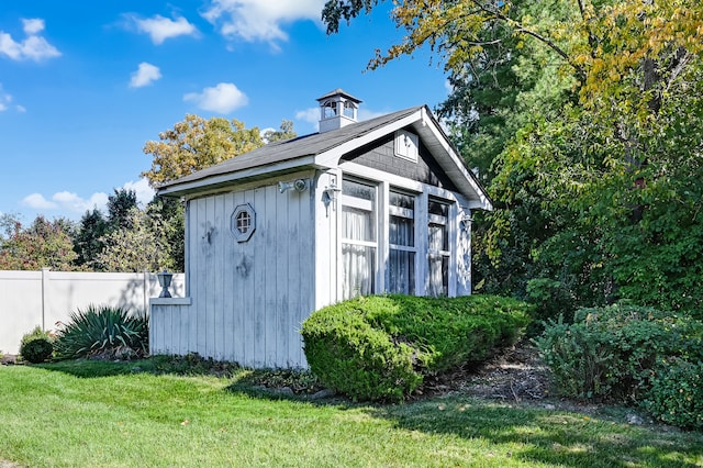 view of outbuilding featuring a lawn