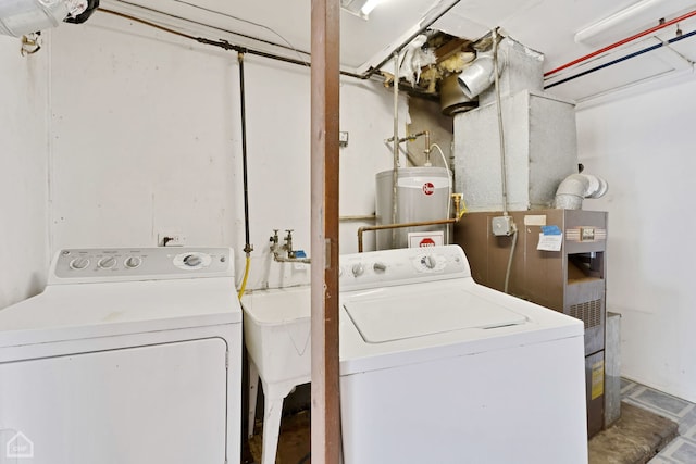 laundry area featuring gas water heater and washing machine and dryer