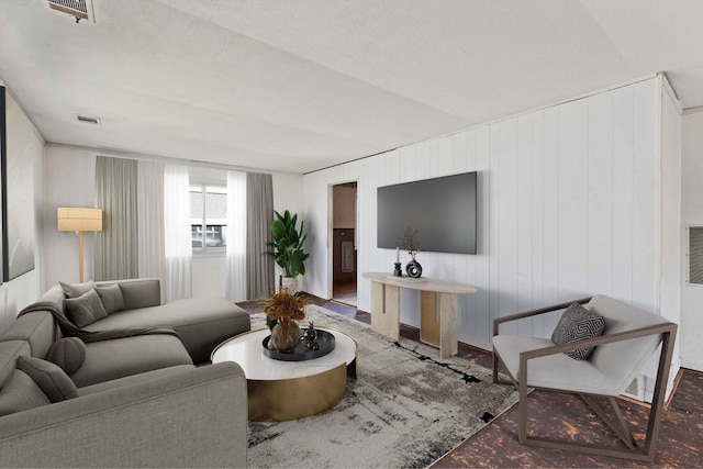 living room with a textured ceiling and hardwood / wood-style floors