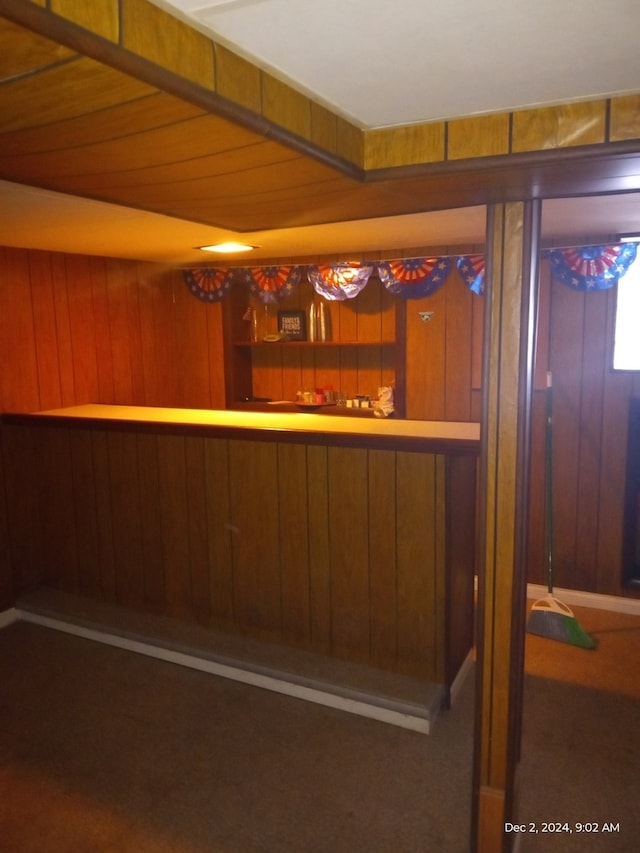 bar with wood walls and dark carpet