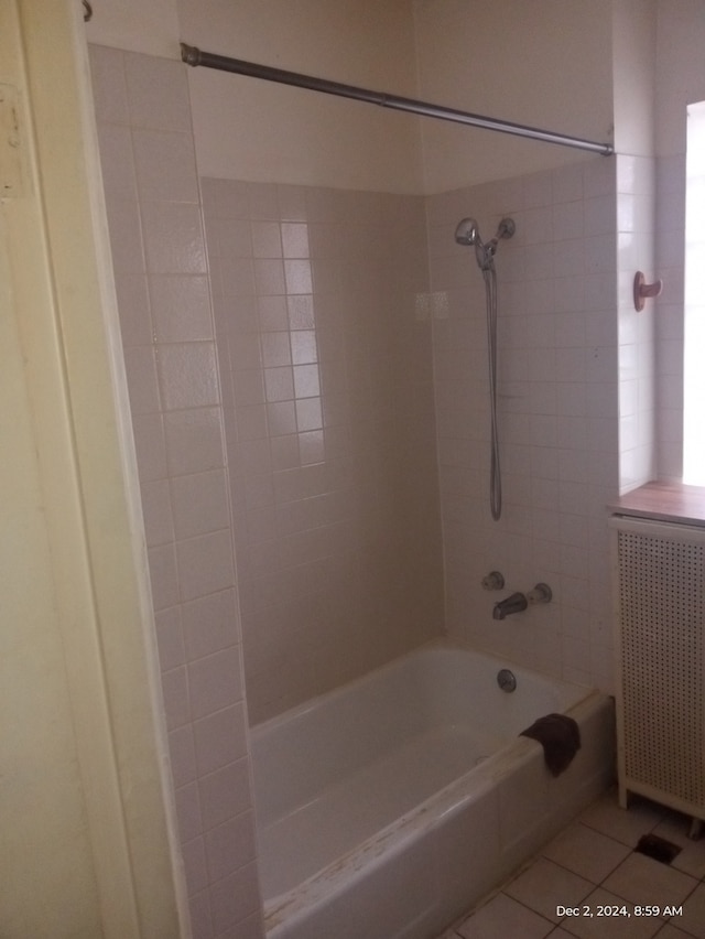 bathroom with tile patterned floors, radiator heating unit, and tiled shower / bath combo