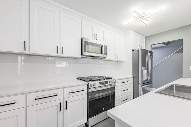 kitchen featuring sink, appliances with stainless steel finishes, and white cabinets