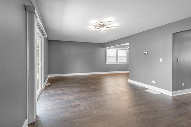 unfurnished room with dark hardwood / wood-style flooring