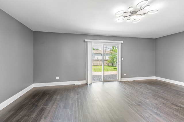 unfurnished room with dark hardwood / wood-style floors