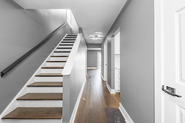 staircase with hardwood / wood-style floors