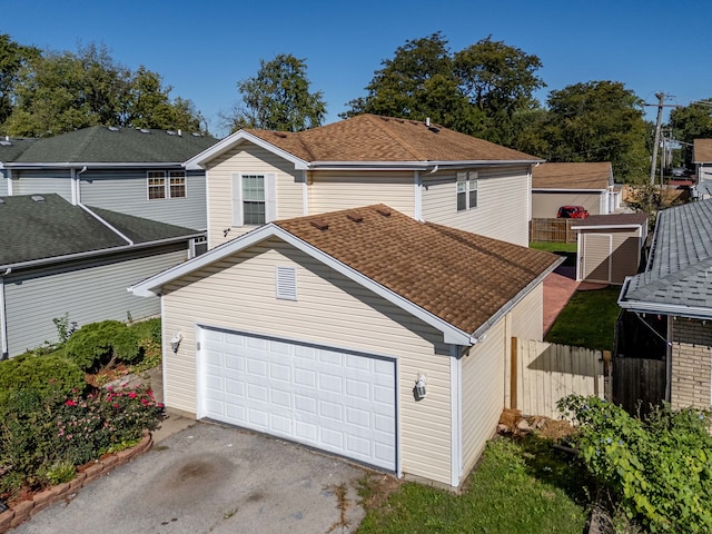 view of front of house with a storage unit and a garage