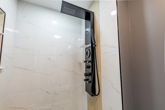 interior details featuring tiled shower