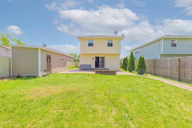 back of property featuring a patio and a yard