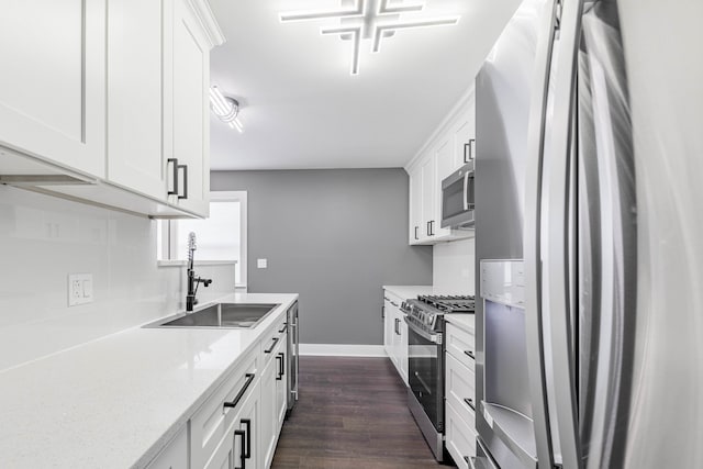 kitchen featuring dark wood-type flooring, stainless steel appliances, sink, and white cabinets